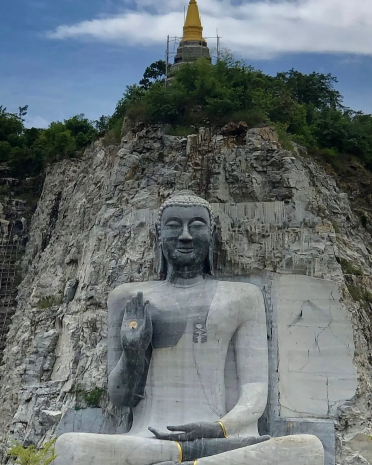 Close-up of a mossy Buddha statue in the Chiang Mai jungle