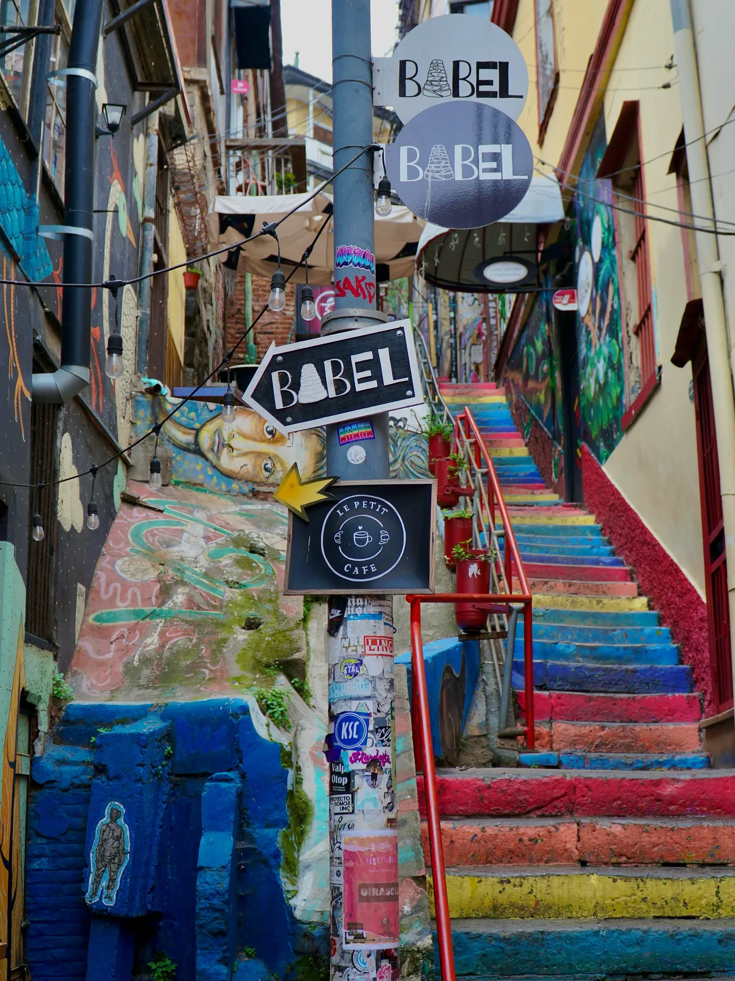 Narrow staircase inside Pasaje Bavestrello in Valparaiso covered in vibrant graffiti and street art leading up to Cerro Alegre