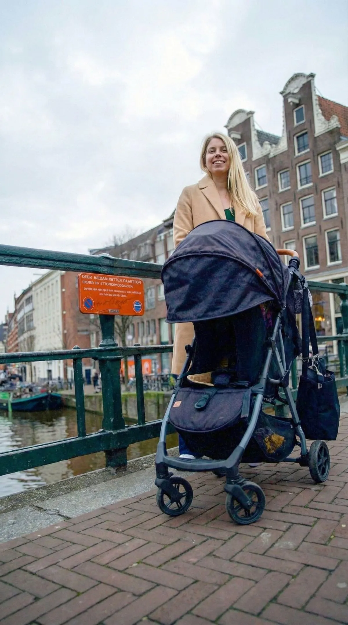 A family navigates the historic basalt-paved Royal Mile in Edinburgh with a rugged all-terrain stroller under festive dusk lighting during Hogmanay.