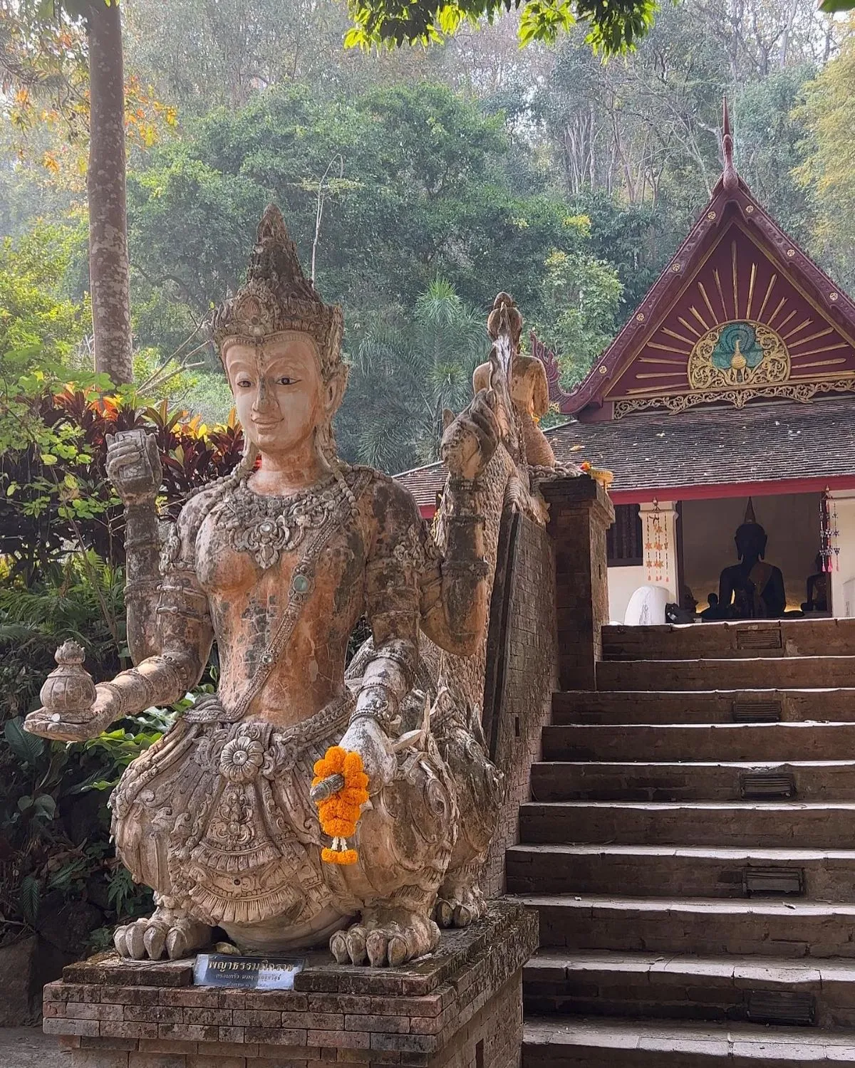 Serene forest shrine with orange monk robes and candles